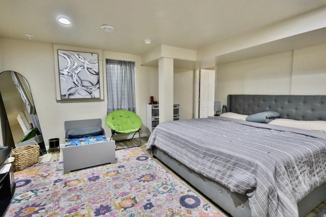 bedroom with wood finished floors and recessed lighting