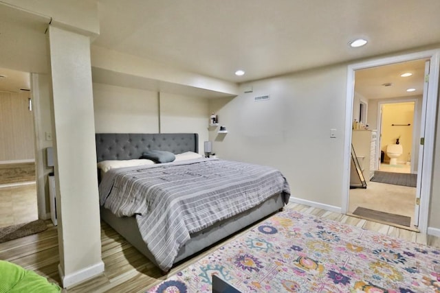 bedroom featuring light wood-style flooring, visible vents, baseboards, and recessed lighting