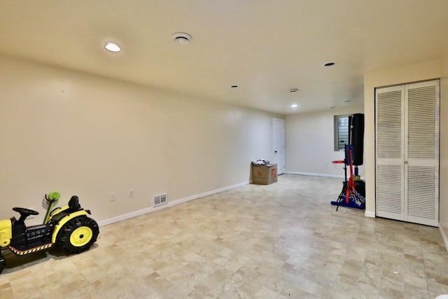 interior space featuring light floors, baseboards, visible vents, and recessed lighting