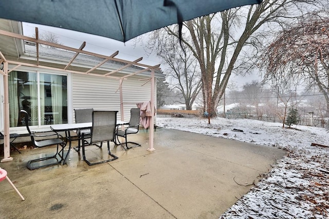 snow covered patio featuring outdoor dining space