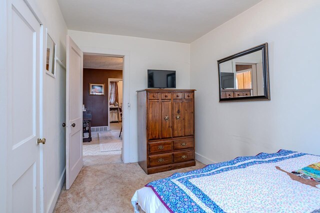 bedroom with carpet and baseboards