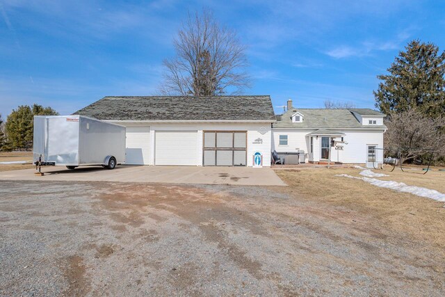 view of front facade featuring entry steps and a detached garage