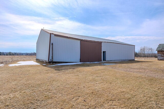 view of pole building with a yard