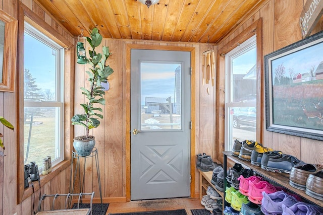 entryway with wooden ceiling and wooden walls