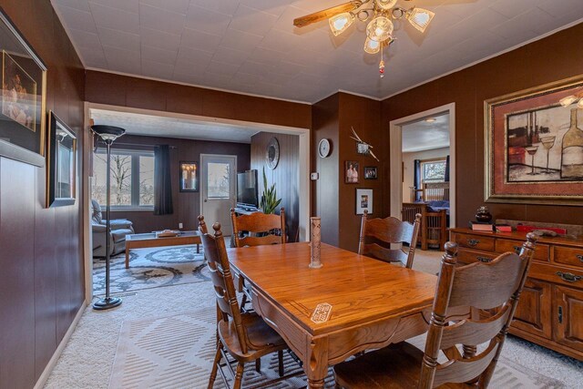 dining space with ceiling fan, a wealth of natural light, and light colored carpet