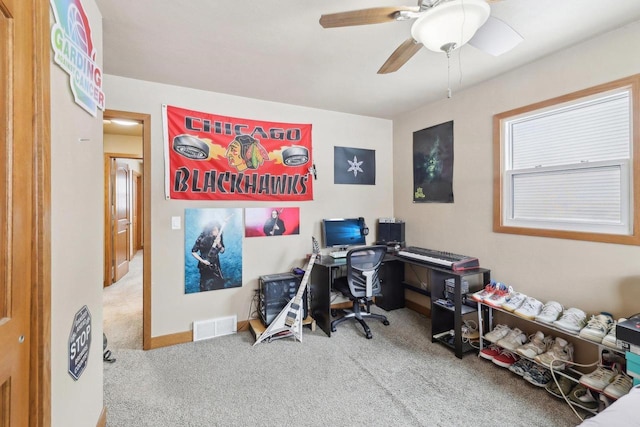 office featuring carpet, visible vents, ceiling fan, and baseboards