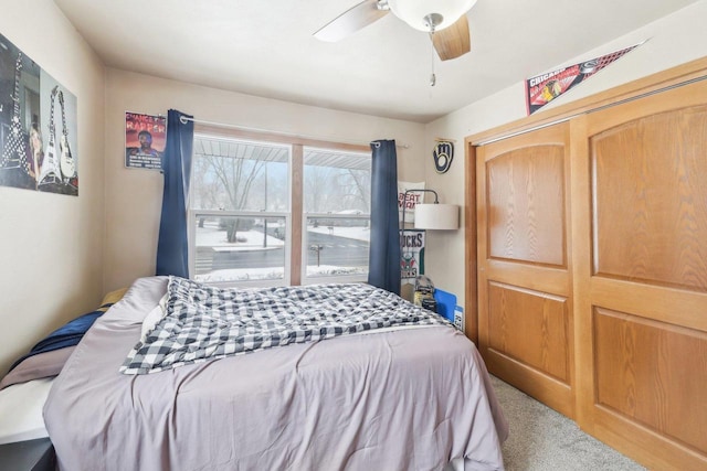 bedroom with ceiling fan, a closet, and carpet flooring