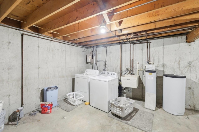 unfinished below grade area featuring independent washer and dryer and a sink