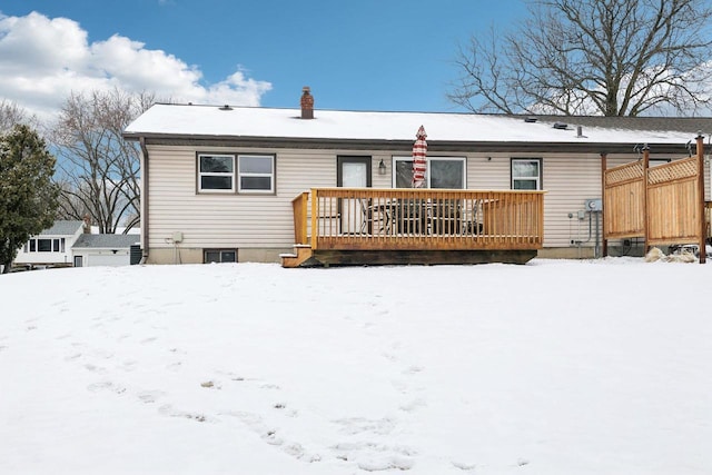 snow covered property with a wooden deck