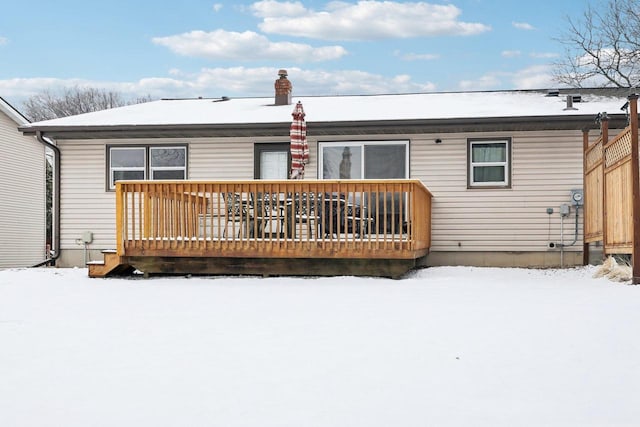 view of snow covered back of property