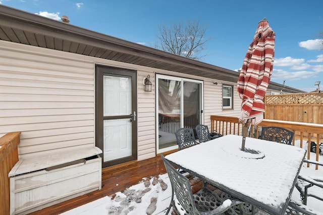 snow covered deck with outdoor dining space