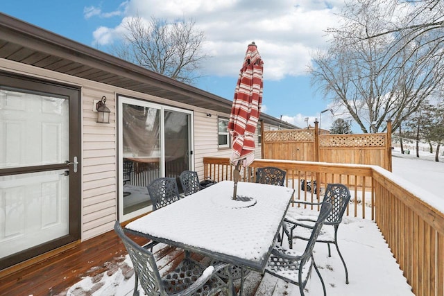 snow covered deck with outdoor dining space