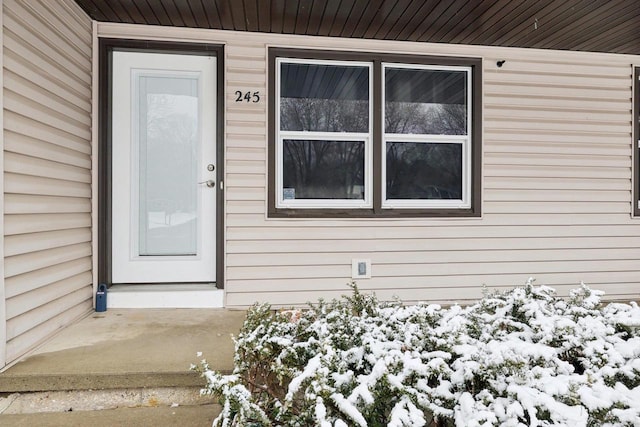 view of snow covered property entrance