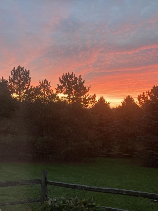 yard at dusk with a rural view