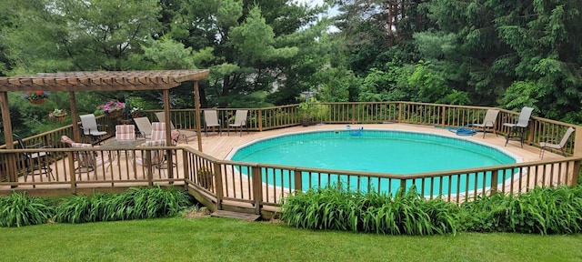 view of pool featuring a fenced in pool, a lawn, and a wooden deck