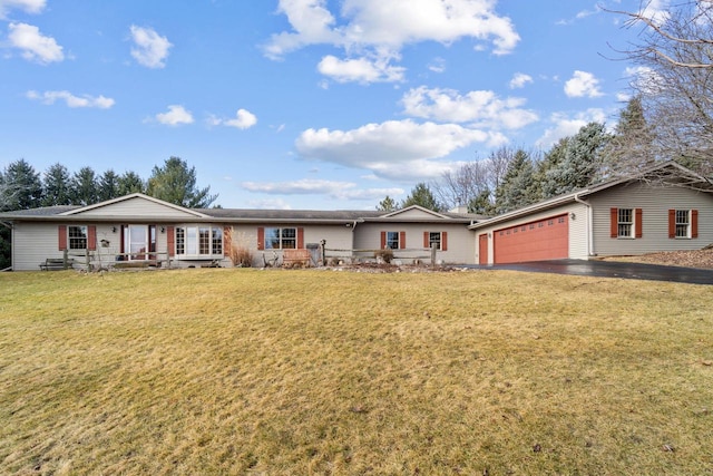 ranch-style home featuring a garage, a front yard, and driveway