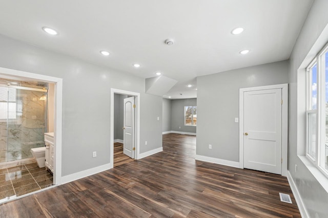 spare room with dark wood-style floors, recessed lighting, visible vents, and baseboards