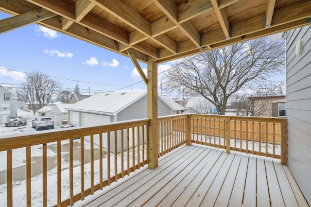 snow covered deck featuring a residential view