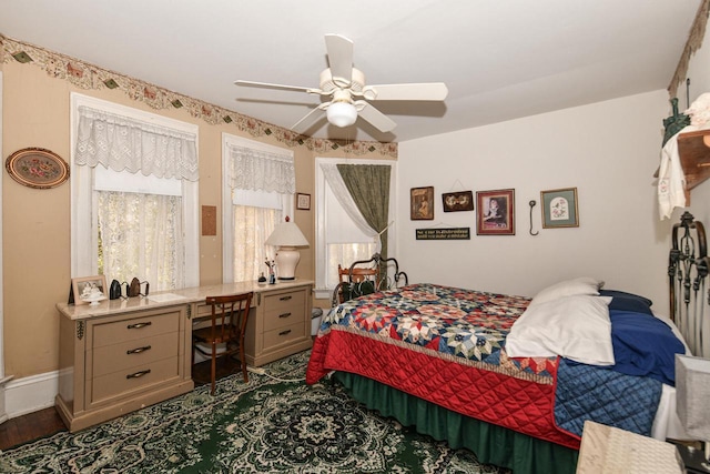 bedroom featuring a ceiling fan and baseboards