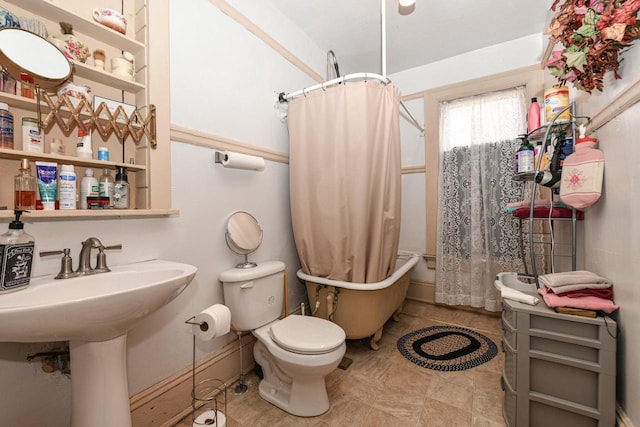 full bathroom featuring shower / bath combo, a sink, and toilet