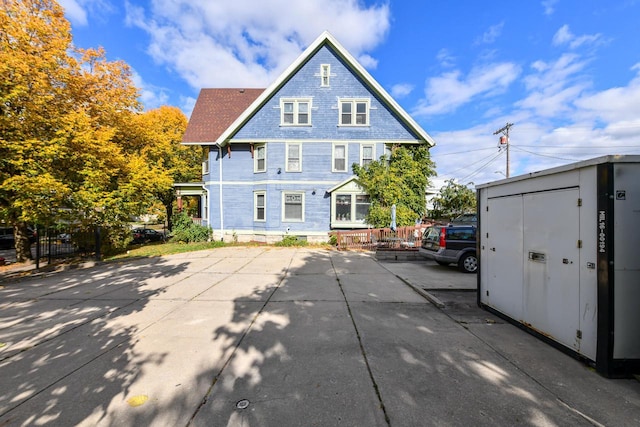 back of property with an outdoor structure and a storage unit