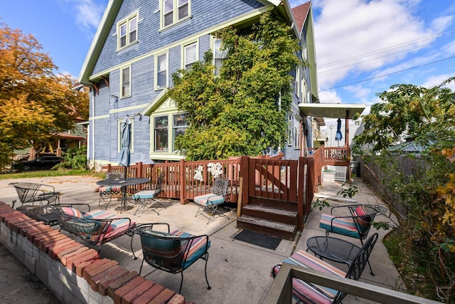 rear view of house featuring a patio and fence