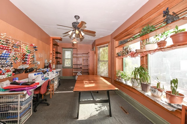 office space featuring ceiling fan and baseboards