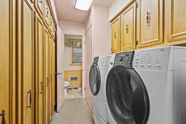 washroom with wallpapered walls, cabinet space, visible vents, light colored carpet, and separate washer and dryer