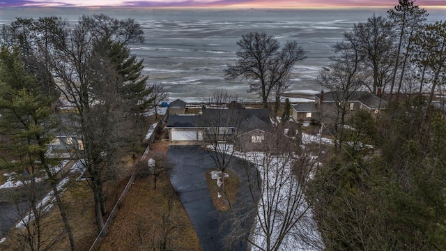 aerial view at dusk with a water view