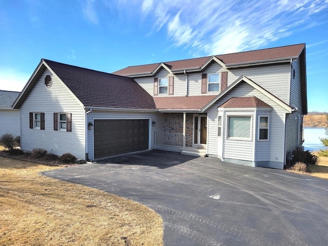 traditional home featuring a garage and driveway