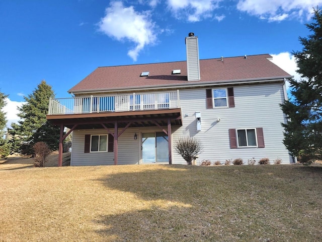 back of house featuring a deck, a lawn, and a chimney