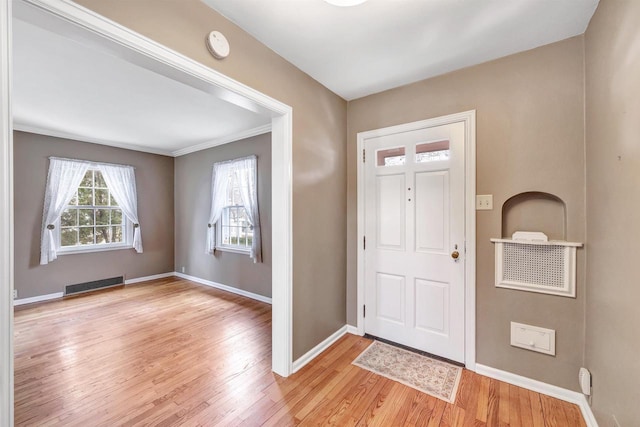 entryway with light wood-style flooring, visible vents, and baseboards