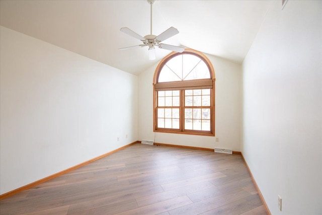 unfurnished room with lofted ceiling, visible vents, baseboards, a ceiling fan, and light wood-type flooring