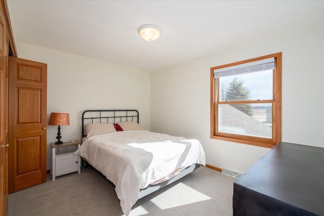 bedroom with carpet, visible vents, and baseboards