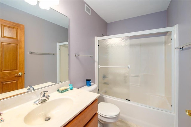 bathroom featuring visible vents, shower / bath combination with glass door, vanity, and toilet