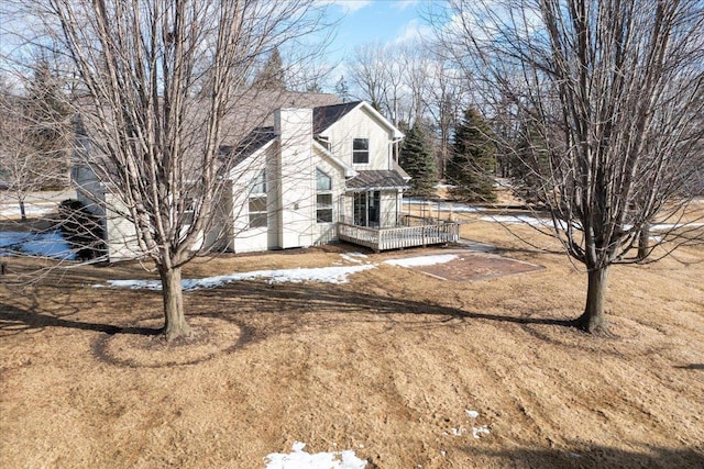 view of side of property featuring a deck