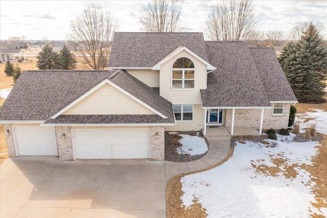 view of front of home with an attached garage, brick siding, concrete driveway, and roof with shingles