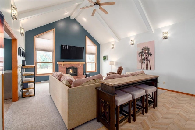 living room with beam ceiling, a brick fireplace, ceiling fan, high vaulted ceiling, and baseboards