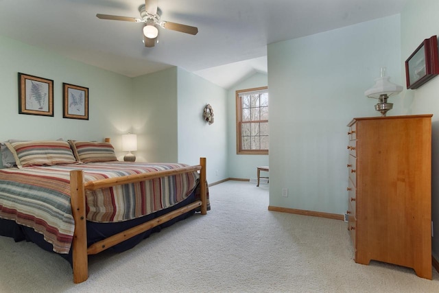 bedroom featuring baseboards, vaulted ceiling, a ceiling fan, and light colored carpet