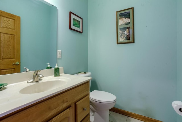 half bath featuring baseboards, vanity, toilet, and tile patterned floors