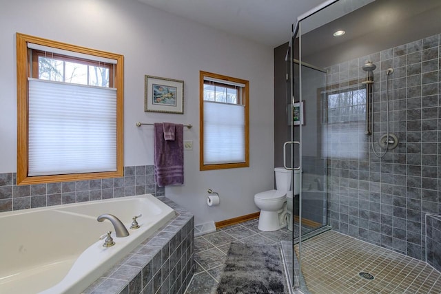 full bath with baseboards, toilet, tile patterned floors, a garden tub, and a shower stall