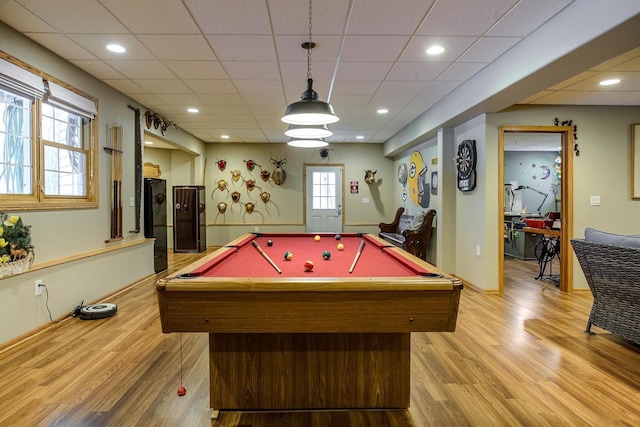 playroom featuring light wood finished floors and a drop ceiling