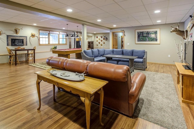 living area with light wood-type flooring, recessed lighting, a drop ceiling, and pool table