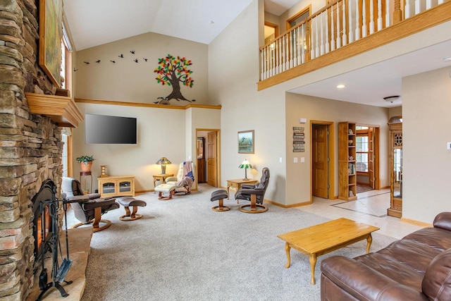 carpeted living room with high vaulted ceiling, a stone fireplace, and baseboards