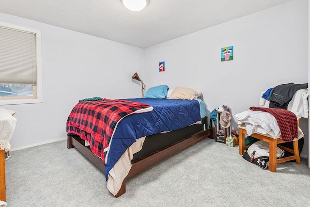 carpeted bedroom featuring baseboards