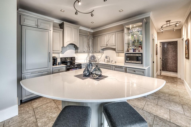 kitchen featuring a sink, black electric range, light countertops, gray cabinets, and stainless steel microwave