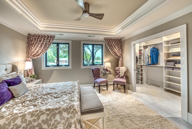 bedroom with a closet, a raised ceiling, ornamental molding, and baseboard heating