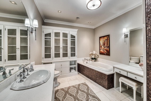 bathroom featuring a garden tub, toilet, vanity, ornamental molding, and tile patterned floors