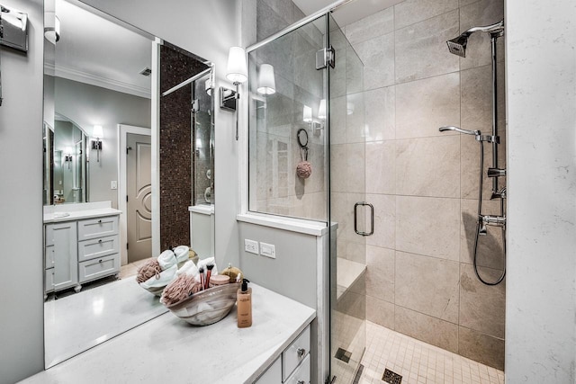 full bath with a stall shower, ornamental molding, and vanity