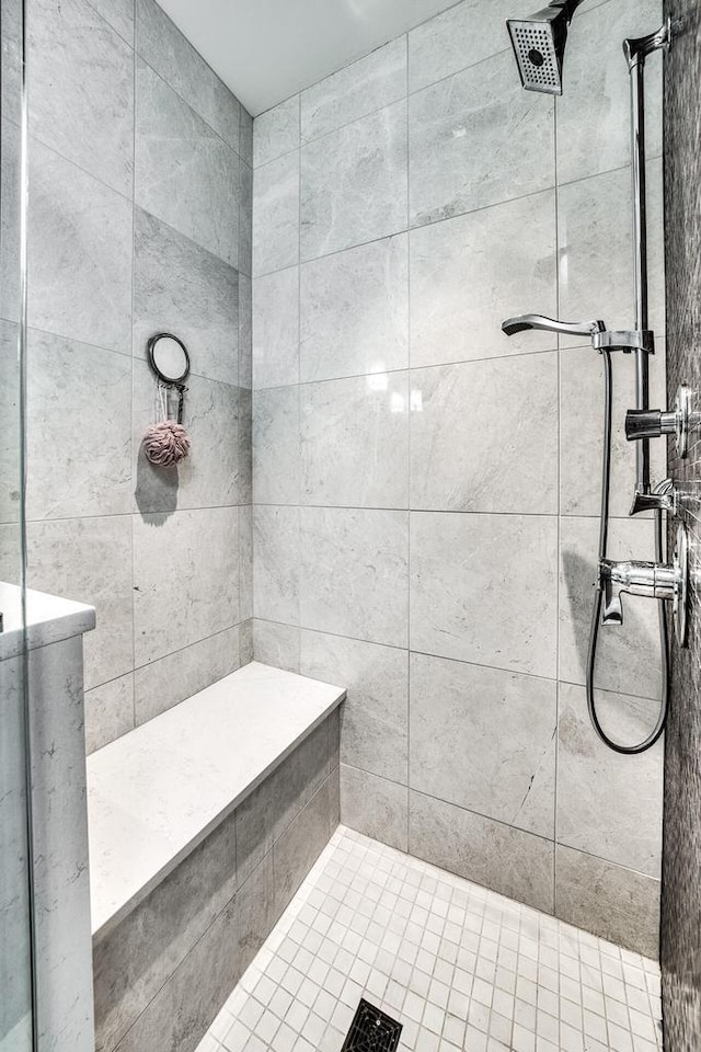 full bath featuring tiled shower